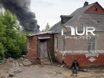 A pillar of smoke is rising from behind a house following the shelling of Russian troops in Kharkiv, Ukraine, on May 17, 2024. NO USE RUSSIA...