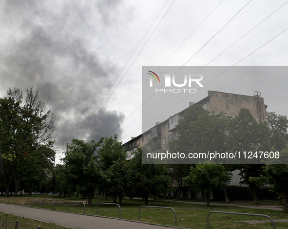 A pillar of smoke is rising from behind an apartment block after the shelling by Russian troops in Kharkiv, Ukraine, on May 17, 2024. NO USE...