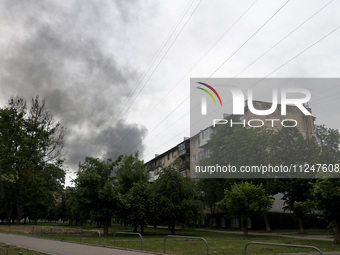 A pillar of smoke is rising from behind an apartment block after the shelling by Russian troops in Kharkiv, Ukraine, on May 17, 2024. NO USE...