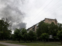 A pillar of smoke is rising from behind an apartment block after the shelling by Russian troops in Kharkiv, Ukraine, on May 17, 2024. NO USE...