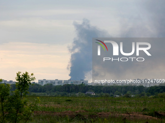 A pillar of smoke is rising from behind apartment blocks after the shelling of Russian troops in Kharkiv, Ukraine, on May 17, 2024. NO USE R...