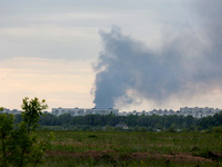 A pillar of smoke is rising from behind apartment blocks after the shelling of Russian troops in Kharkiv, Ukraine, on May 17, 2024. NO USE R...