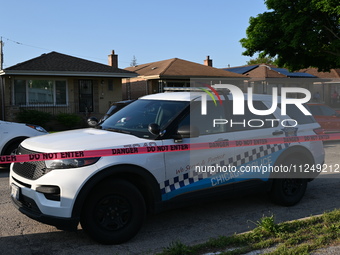 A police vehicle is in front of the home where the homicide is occurring. A 54-year-old male victim is being shot in the chest and killed wh...