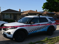 A police vehicle is in front of the home where the homicide is occurring. A 54-year-old male victim is being shot in the chest and killed wh...