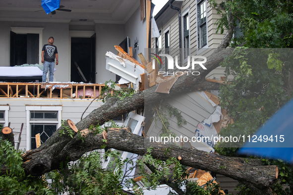 A man is looking out from inside a destroyed home in the Houston Heights at Ashland St. and 27th St. in Houston, United States, on May 17, 2...