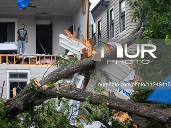 A man is looking out from inside a destroyed home in the Houston Heights at Ashland St. and 27th St. in Houston, United States, on May 17, 2...