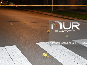 Evidence markers are being placed on the ground where shell casings are being discovered at the crime scene. Three people are being shot in...