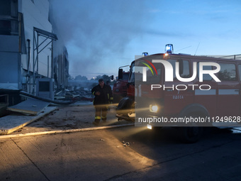 Rescuers are working at a civil enterprise damaged by a Russian missile attack in Odesa, Ukraine, on May 17, 2024. (