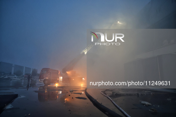 Rescuers are working at a civil enterprise damaged by a Russian missile attack in Odesa, Ukraine, on May 17, 2024. 