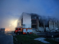 Rescuers are working at a civil enterprise damaged by a Russian missile attack in Odesa, Ukraine, on May 17, 2024. (