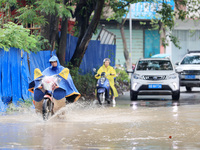 People are driving through a flooded urban road in the rain on Xinxing Road in Rongan county, Liuzhou city, South China's Guangxi Zhuang Aut...