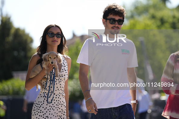 Charles Leclerc of Monaco and Ferrari SF-24 is walking on the paddock with his girlfriend and their little dog prior to the Qualify of the F...