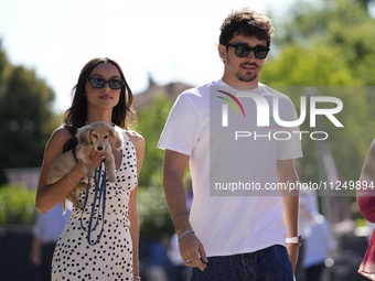 Charles Leclerc of Monaco and Ferrari SF-24 is walking on the paddock with his girlfriend and their little dog prior to the Qualify of the F...