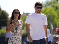 Charles Leclerc of Monaco and Ferrari SF-24 is walking on the paddock with his girlfriend and their little dog prior to the Qualify of the F...