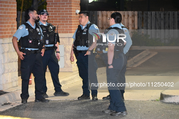 Police officers are gathering at the crime scene where the male victim is shot. A 42-year-old male victim is wounded in Chicago, Illinois, U...