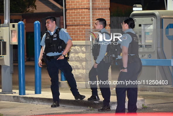 Police officers are gathering at the crime scene where the male victim is shot. A 42-year-old male victim is wounded in Chicago, Illinois, U...