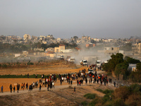 Palestinians are walking towards trucks transporting aid that is being delivered into Gaza through a U.S.-built pier, amid the ongoing confl...