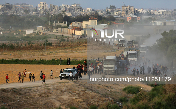 Palestinians are grabbing aid from a truck that is being delivered into Gaza through a U.S.-built pier, amid the ongoing conflict between Is...