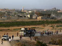 Palestinians are grabbing aid from a truck that is being delivered into Gaza through a U.S.-built pier, amid the ongoing conflict between Is...