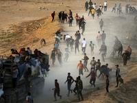 Palestinians are grabbing aid from a truck that is being delivered into Gaza through a U.S.-built pier, amid the ongoing conflict between Is...