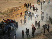 Palestinians are grabbing aid from a truck that is being delivered into Gaza through a U.S.-built pier, amid the ongoing conflict between Is...