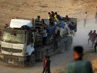 Palestinians are grabbing aid from a truck that is being delivered into Gaza through a U.S.-built pier, amid the ongoing conflict between Is...