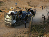 Palestinians are grabbing aid from a truck that is being delivered into Gaza through a U.S.-built pier, amid the ongoing conflict between Is...