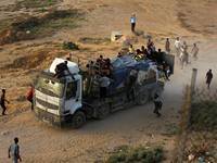 Palestinians are grabbing aid from a truck that is being delivered into Gaza through a U.S.-built pier, amid the ongoing conflict between Is...