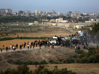 Palestinians are grabbing aid from a truck that is being delivered into Gaza through a U.S.-built pier, amid the ongoing conflict between Is...