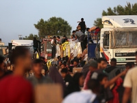 Palestinians are climbing onto trucks to grab aid that is being delivered into Gaza through a U.S.-built pier, amid the ongoing conflict bet...