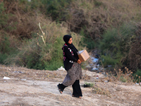 Palestinians are carrying boxes of aid that are being delivered into Gaza through a U.S.-built pier, amid the ongoing conflict between Israe...