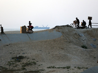 Palestinians are carrying boxes of aid that are being delivered into Gaza through a U.S.-built pier, amid the ongoing conflict between Israe...