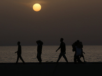 Palestinians are carrying boxes of aid that are being delivered into Gaza through a U.S.-built pier, amid the ongoing conflict between Israe...