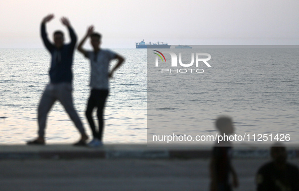 Ships are being pictured near a U.S.-built pier, as seen from central Gaza Strip, on May 18, 2024 