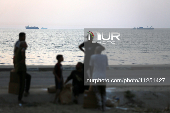 Ships are being pictured near a U.S.-built pier, as seen from central Gaza Strip, on May 18, 2024 