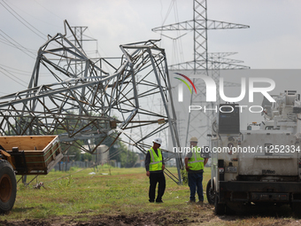 A mangled transmission tower is being seen at the intersection of Gardendale Dr. and Antoine Dr. as crews throughout Houston are working to...