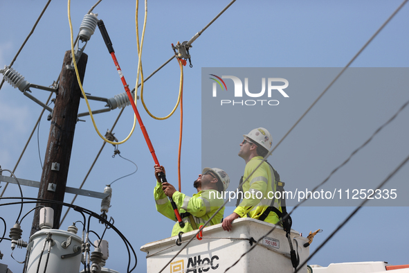 Electrical crews are working on power lines in the Spring Branch neighborhood of Houston, Texas. 