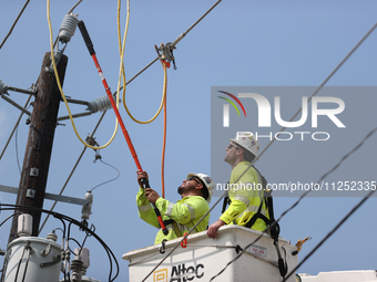 Electrical crews are working on power lines in the Spring Branch neighborhood of Houston, Texas. (