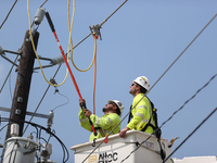 Electrical crews are working on power lines in the Spring Branch neighborhood of Houston, Texas. (