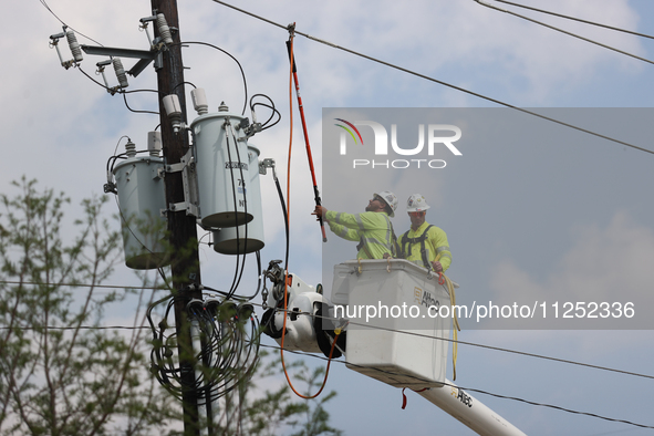 Electrical crews are working on power lines in the Spring Branch neighborhood of Houston, Texas. 