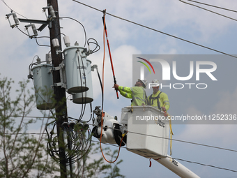 Electrical crews are working on power lines in the Spring Branch neighborhood of Houston, Texas. (