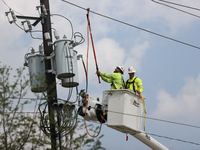 Electrical crews are working on power lines in the Spring Branch neighborhood of Houston, Texas. (