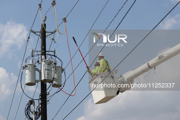 Electrical crews are working on power lines in the Spring Branch neighborhood of Houston, Texas. 