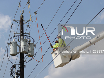 Electrical crews are working on power lines in the Spring Branch neighborhood of Houston, Texas. (