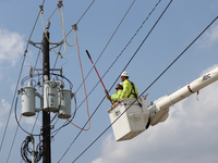 Electrical crews are working on power lines in the Spring Branch neighborhood of Houston, Texas. (