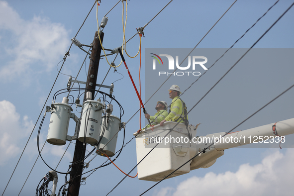 Electrical crews are working on power lines in the Spring Branch neighborhood of Houston, Texas. 