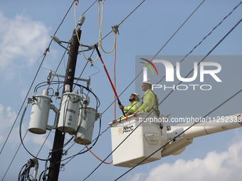 Electrical crews are working on power lines in the Spring Branch neighborhood of Houston, Texas. (