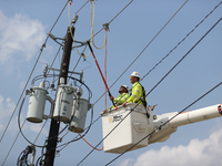 Electrical crews are working on power lines in the Spring Branch neighborhood of Houston, Texas. (