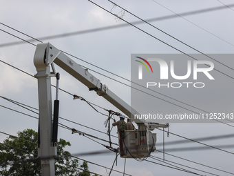 Electrical crews are working on power lines in the Spring Branch neighborhood of Houston, Texas. (