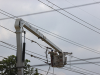 Electrical crews are working on power lines in the Spring Branch neighborhood of Houston, Texas. (